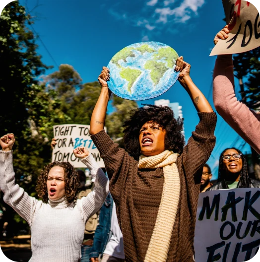 Protesters holding signs and a globe