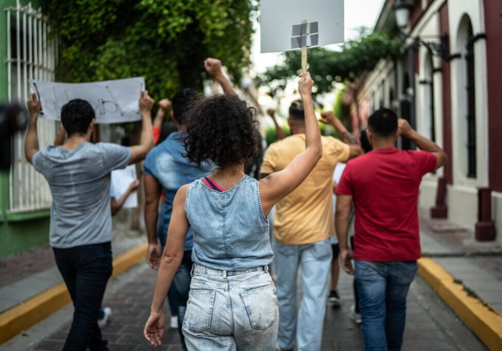 Protesters marching with signs on street